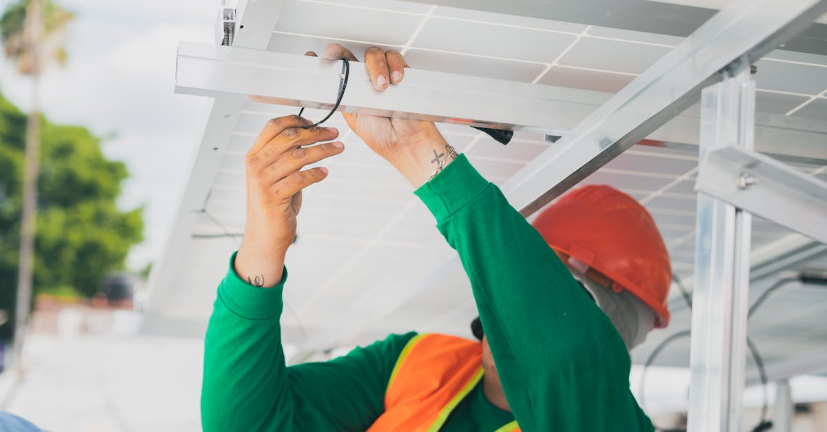 A solar technician in PPE installs a solar panel, showcasing renewable energy work.